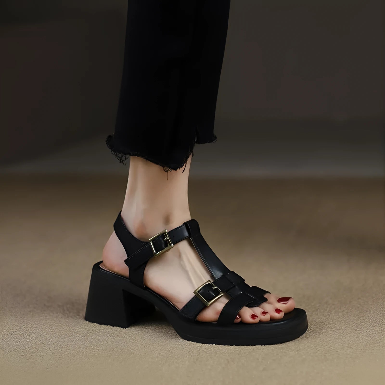 Women's black retro sandals with a chunky heel, platform, and T-shaped buckle fastening.