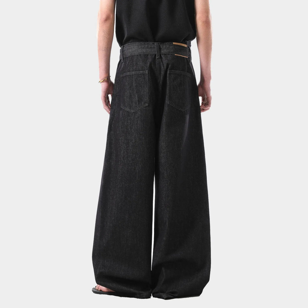Women's black high-waist straight-leg jeans with retro gold wash detailing on denim.