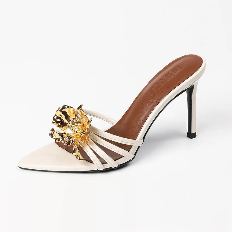 Gold women's stiletto open toe sandals with metal flower decoration on microfiber upper.