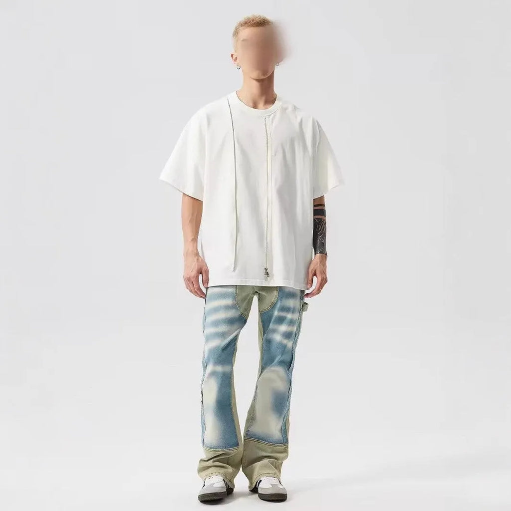Yellow and blue patchwork distressed denim jeans with a mid-rise waist and zip fly.