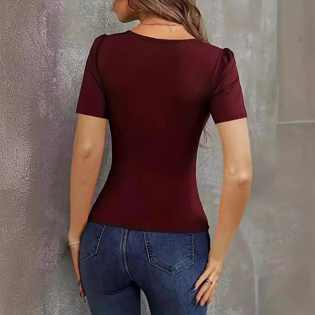 Women's wine red polyester knitted pullover with slim fit and low neckline on a hanger.