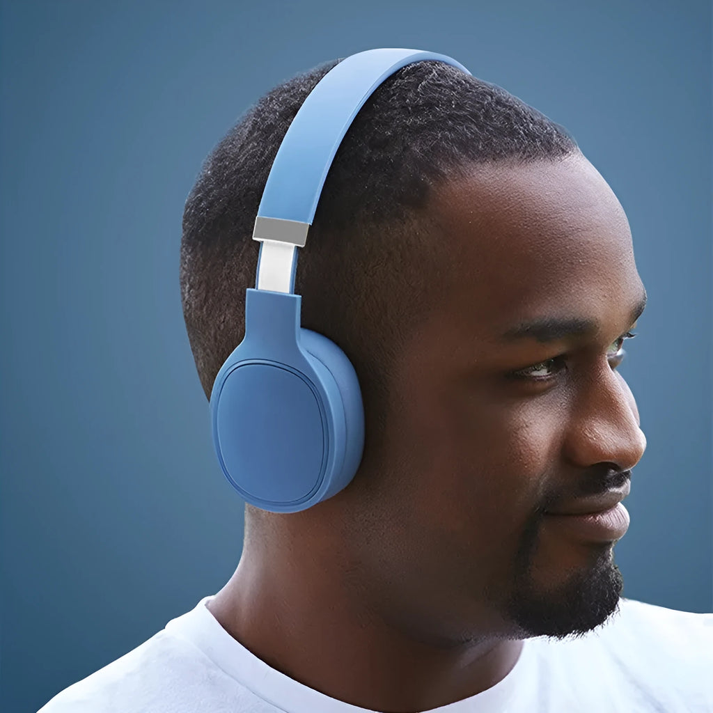 True wireless Bluetooth headset in four colour options showing head-mounted design with USB charging port