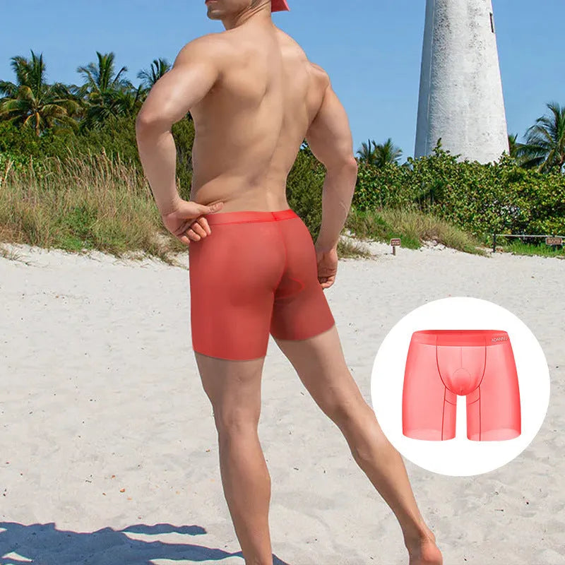 Men's low waist ice silk boxer shorts in solid orange colour, showing knit fabric texture.