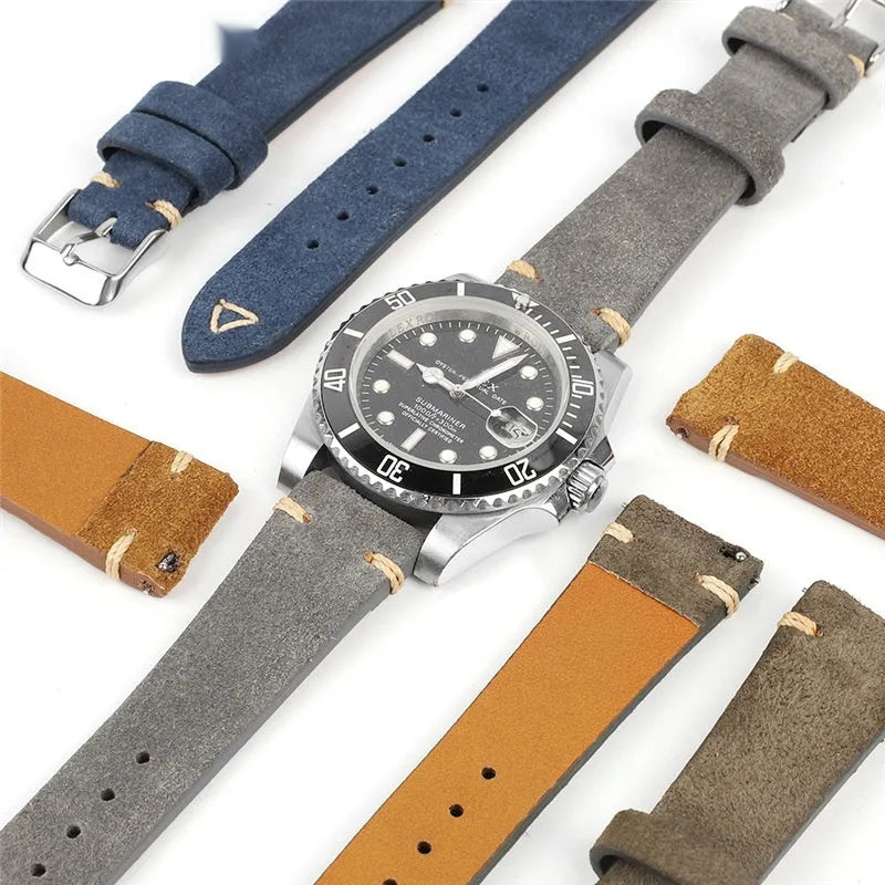 Brown suede leather watch strap with small waist design shown next to blue, grey, and army green colour options.