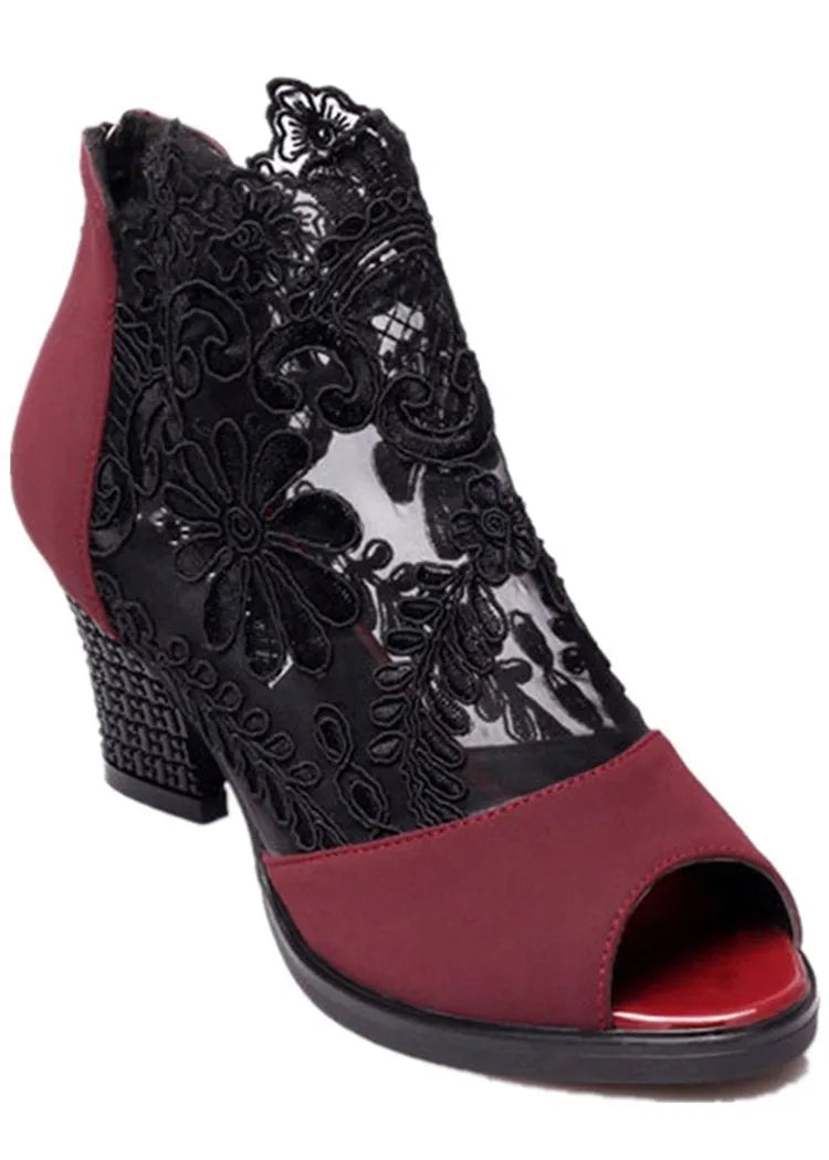 Women's black lace gladiator sandals with a square high heel and peep toe, showing zip closure