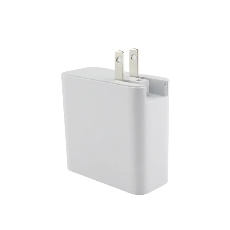 Black 48W USB-C four-port fast wall charger with UK plug on a wooden surface
