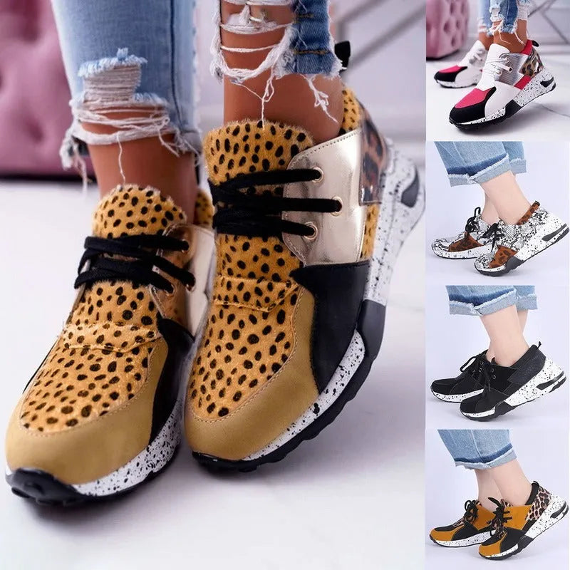 Women's black suede casual sneakers with a low wedge heel and round toe on a white background.