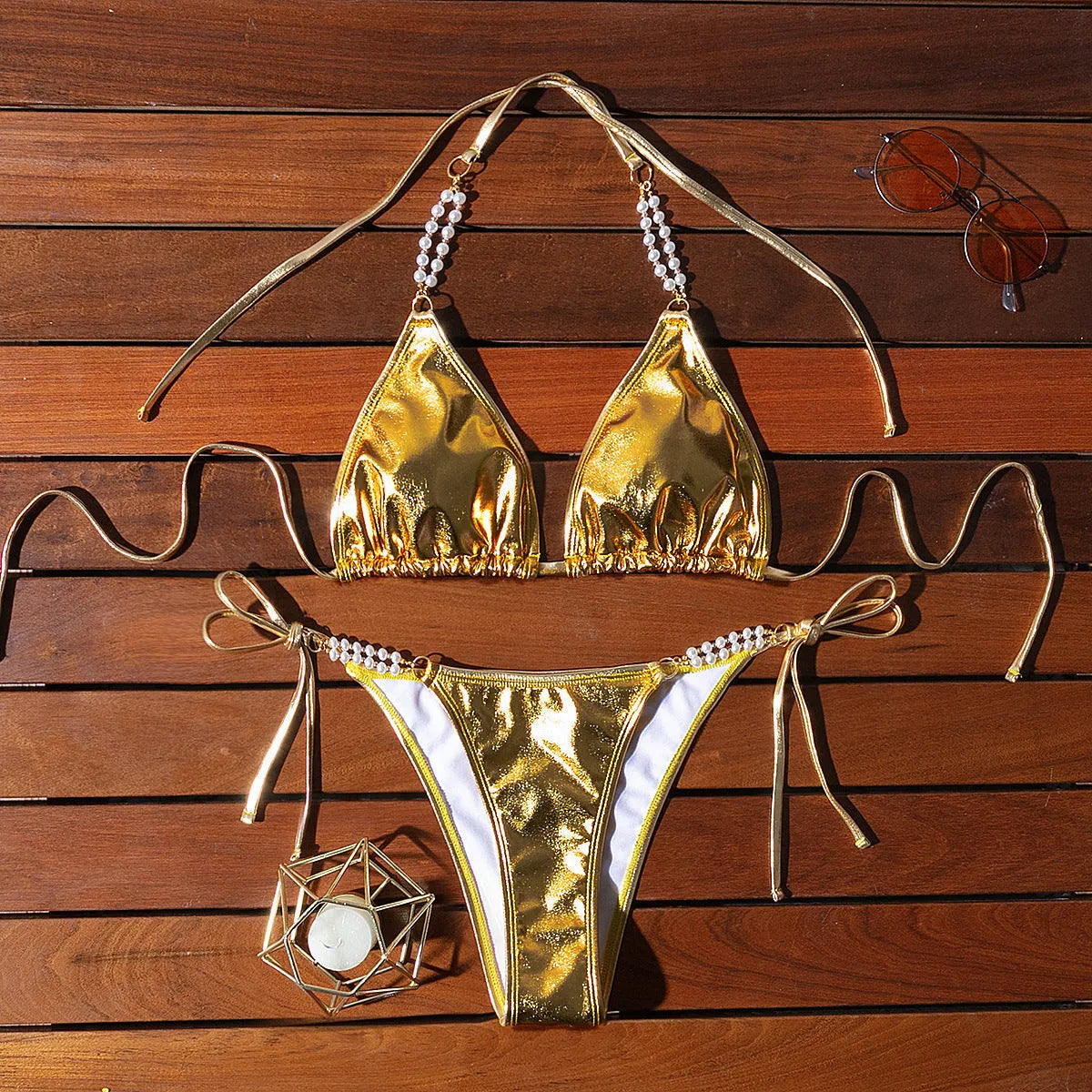 Gold halter neck bikini with lace-up front and pearl chain decoration
