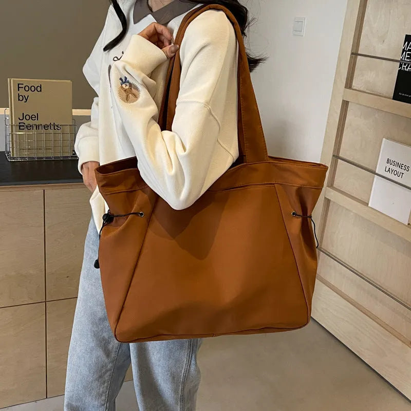 Foldable Oxford cloth commuter tote bag in street trend style, shown in multiple colour options.
