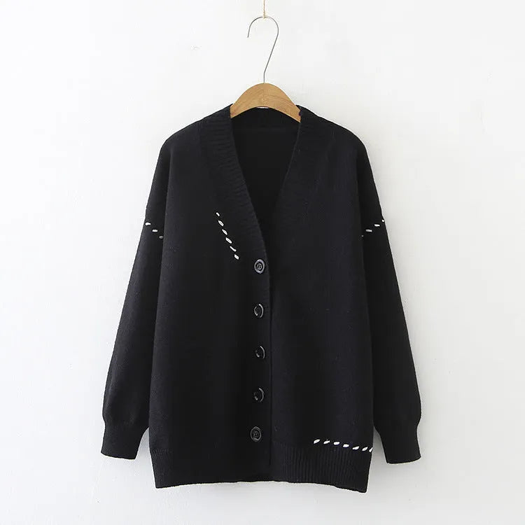 Women's loose black knitted cardigan coat with long sleeves.