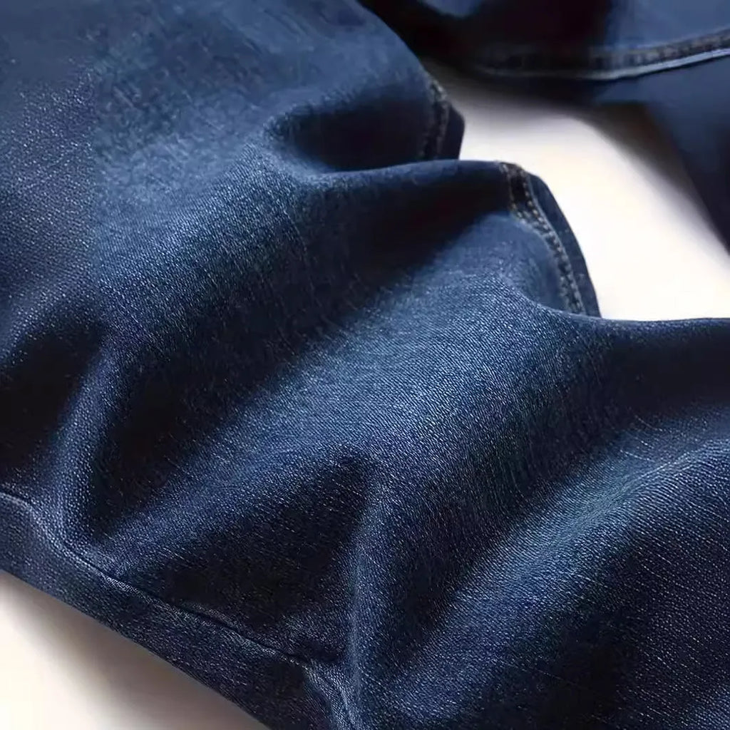 Man wearing dark blue slim-fit skinny jeans with a medium-elastic waist and zipper fly.