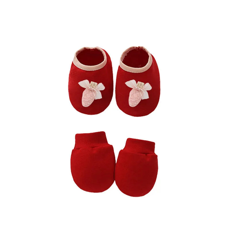 Set of white, light blue, and grey cotton baby pullover caps, gloves, and foot covers for infants.
