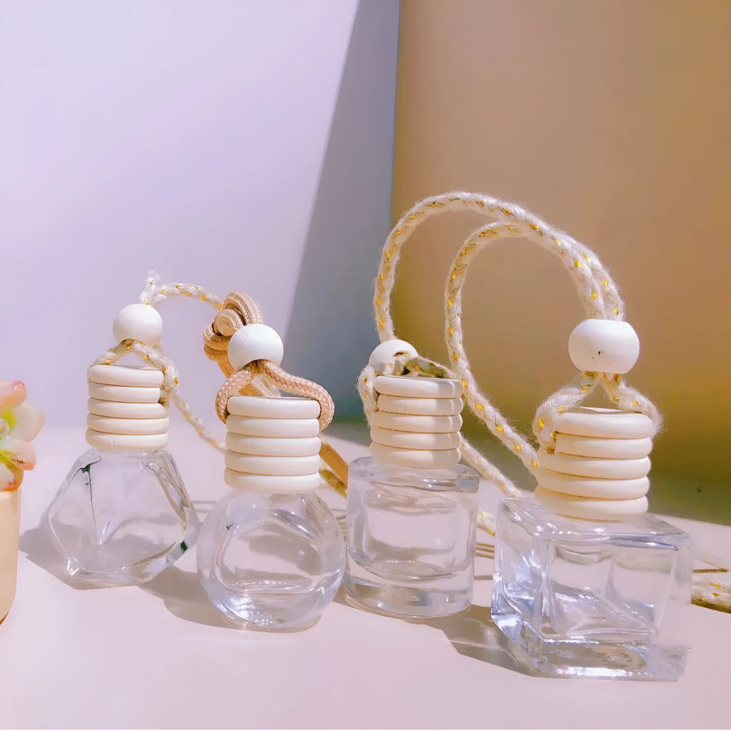 Car air vent perfume pendant showing cylinder, diamond, flat drum, and square glass bottle designs