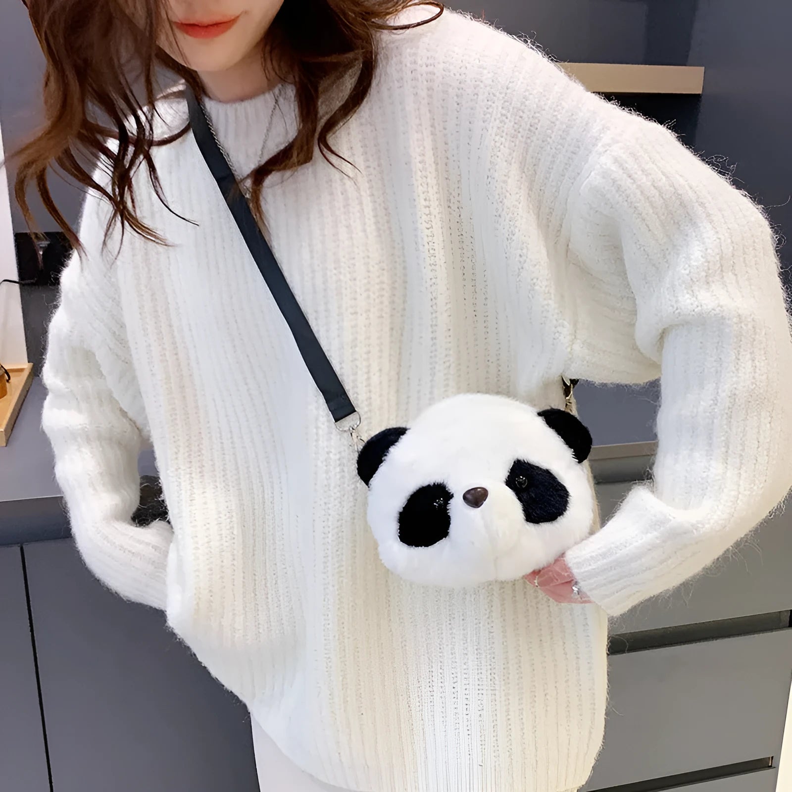 Soft plush crossbody bag with panda head design, cylindrical shape.
