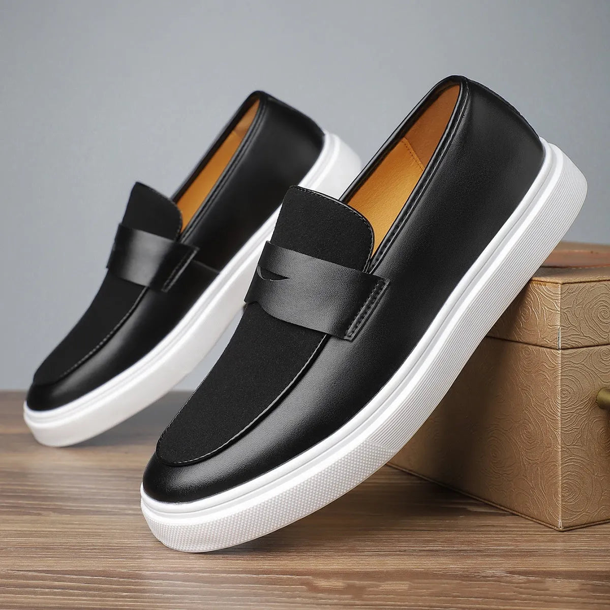 Men's black slip-on casual shoes with tassel detail and round toe