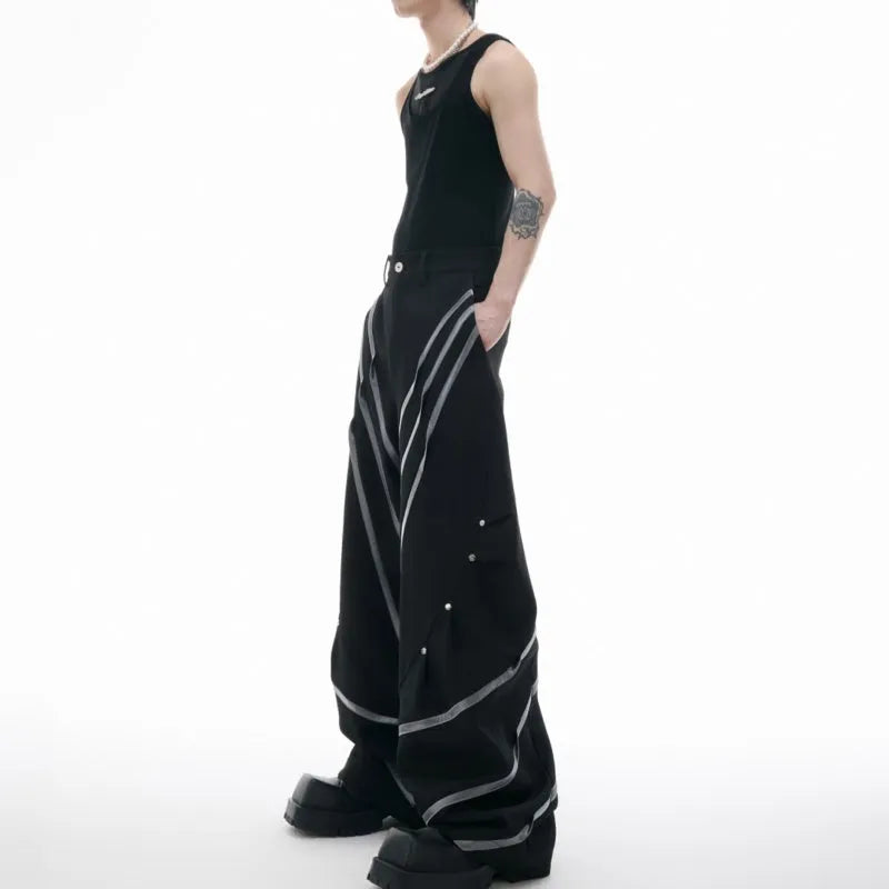 Men's black and white polyester trousers with 3D cutting, metal rivet stripes, and pleated front.