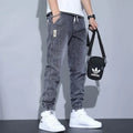 Men's slim fit straight-leg jeans in blue denim with high waist and ankle-tied style