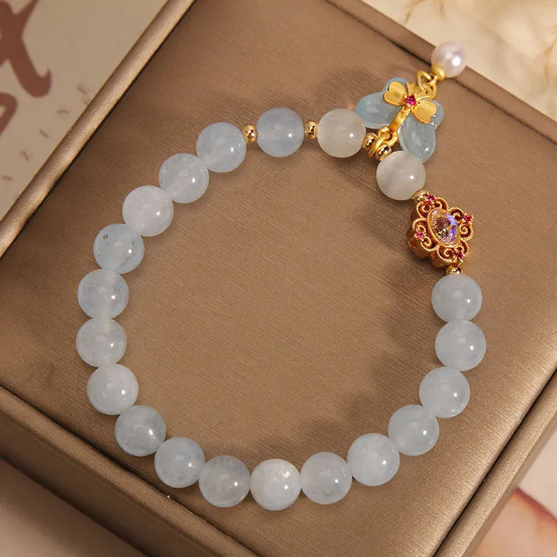 Women's aquamarine butterfly pendant crystal bracelet with rhinestone detailing on adjustable chain