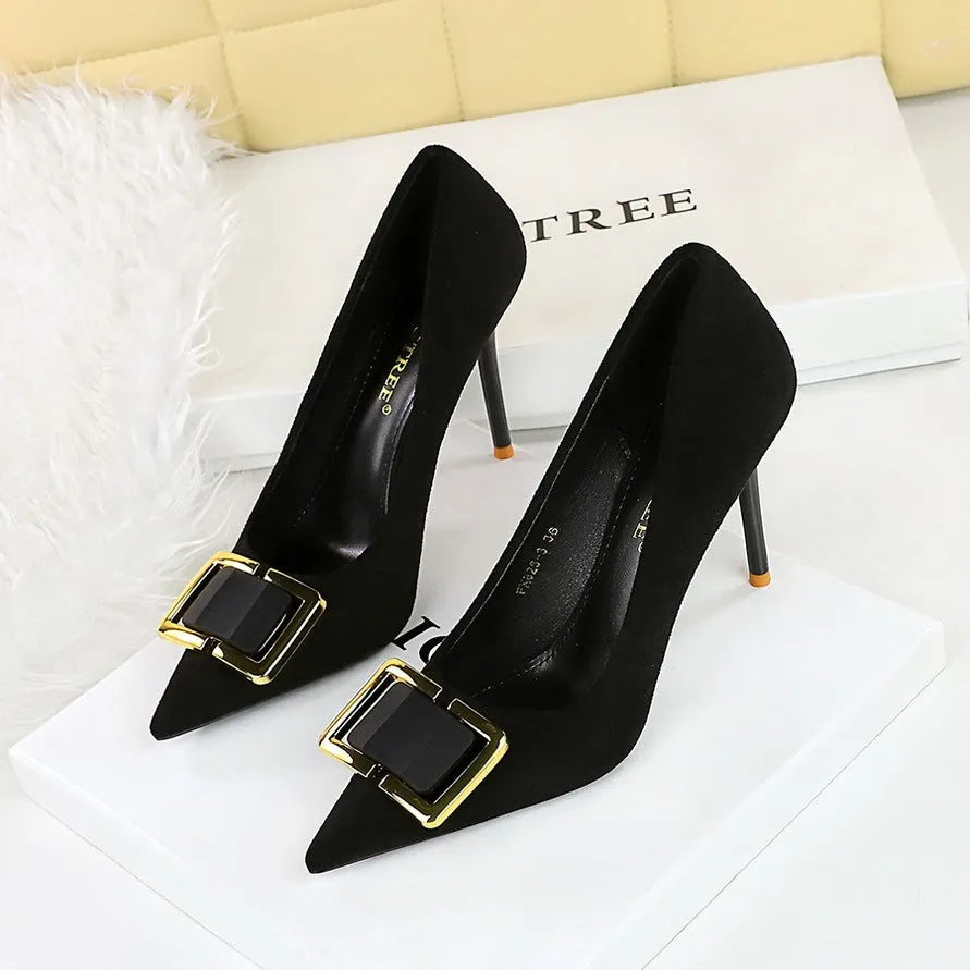 Black suede women's high heel shoes with a pointed toe and a tall, slender stiletto heel.