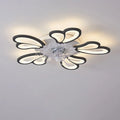 Modern white ceiling fan light with six-blade design and integrated light fitting on a room ceiling.