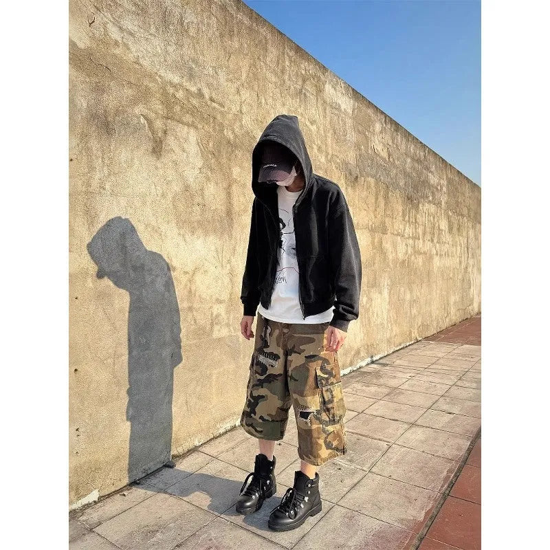 Men's loose straight-leg jeans in camouflage colour with cropped length and distressed patch detailing
