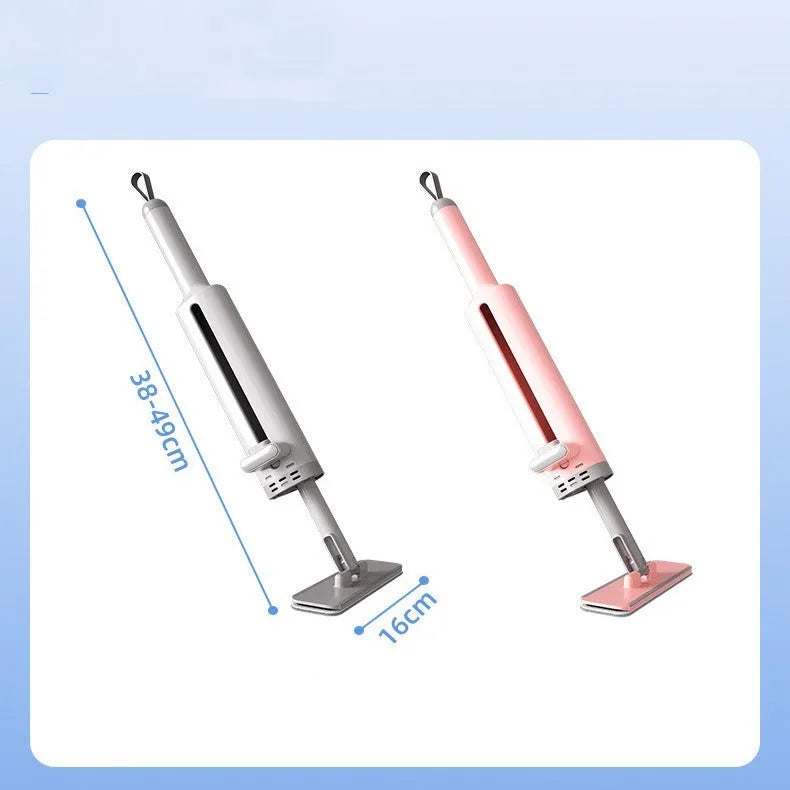 Pink self-squeezing rotatable mini flat mop with microfiber pad on a hardwood floor.