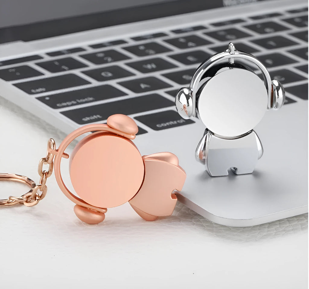 Silver and rose gold metal USB flash drives with musician cartoon designs showing compact dimensions