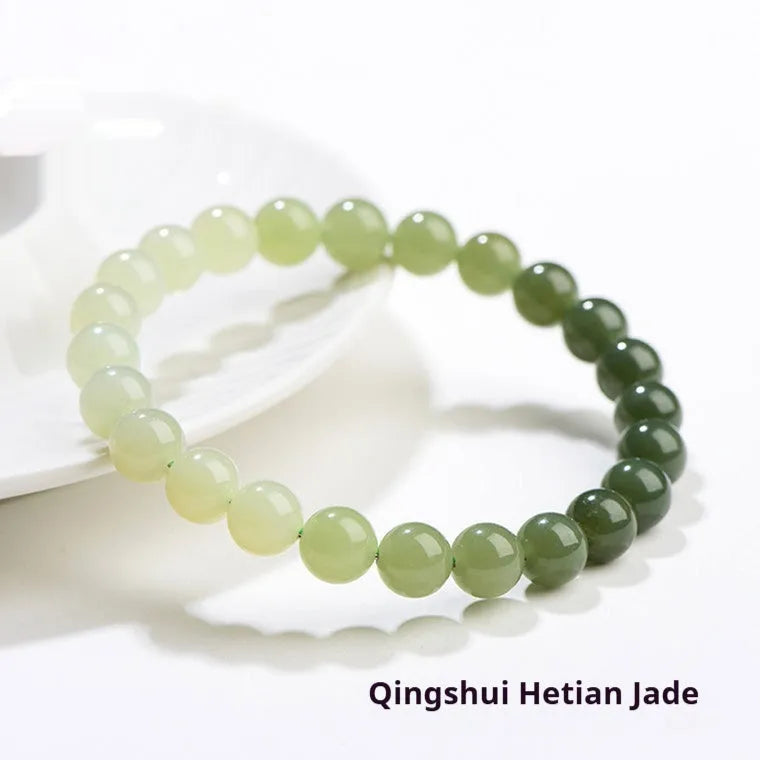 Natural clear water Hetian jade bracelet with gradient round beads on a wrist.