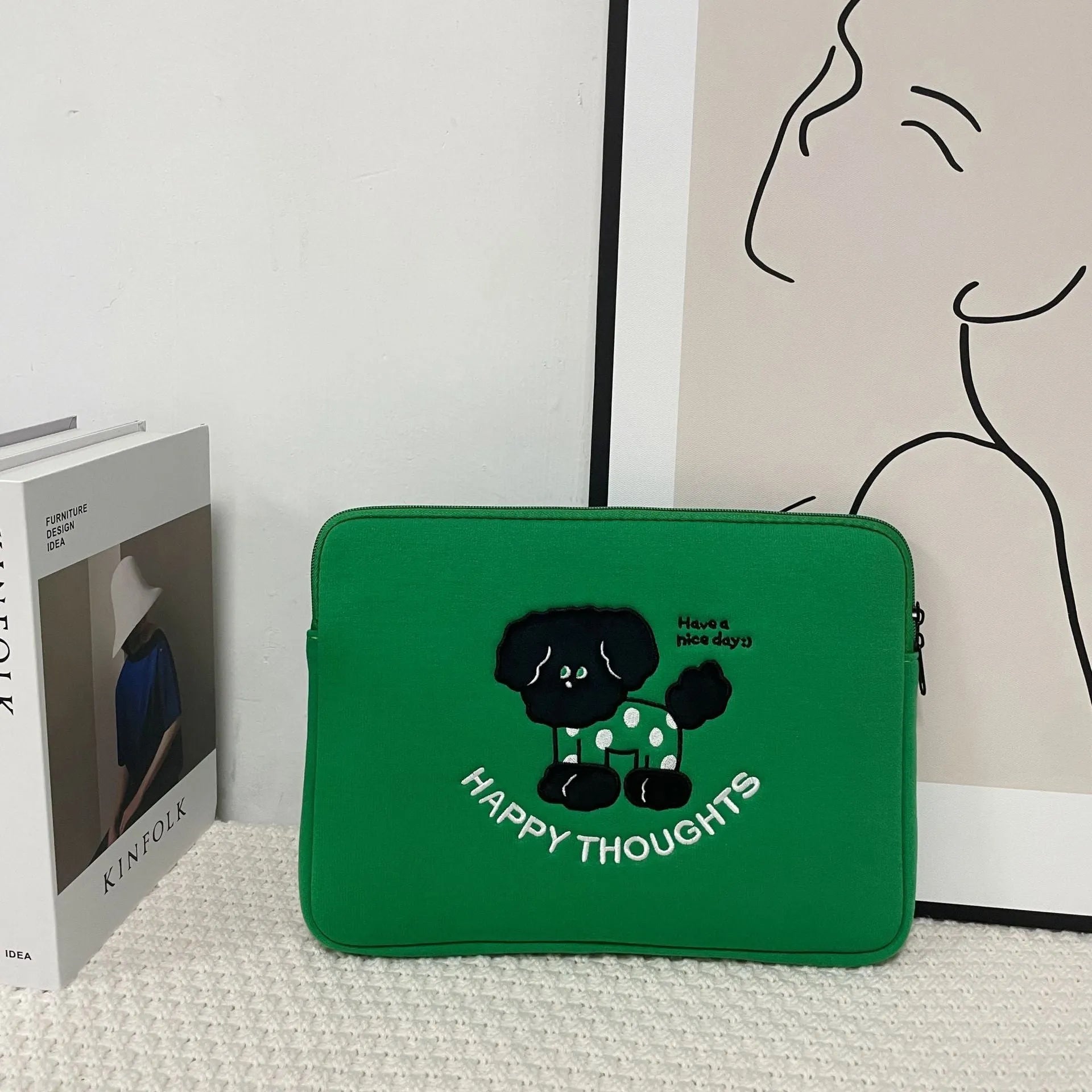 Polyester laptop sleeve with colourful embroidered animal design for a 15.6-inch laptop.