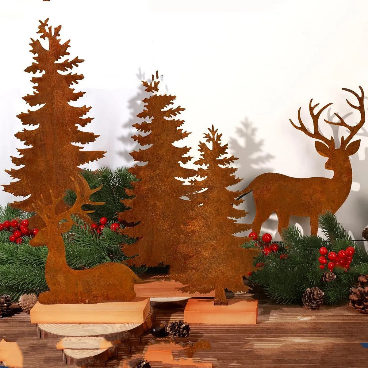 Three metal Christmas tree ornaments with rusty finish featuring elk designs