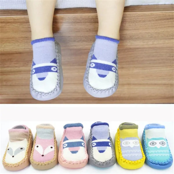 Pair of pastel coloured baby socks with anti-slip dots on the sole, shown flat.