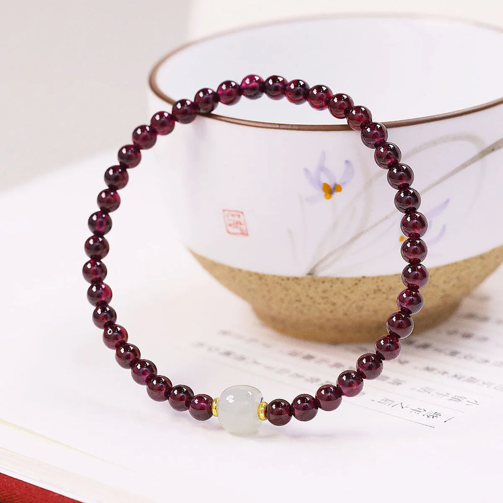 Women's garnet bracelet with U-shaped design and polished stones in 4mm or 6mm diameters