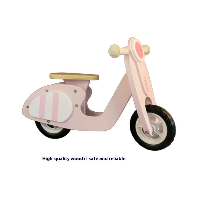 Pink wooden balance scooter for toddlers with 10-inch wheels.