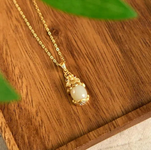 Hetian jade antique gold pendant necklace with cartoon pi xiu design and cross chain.