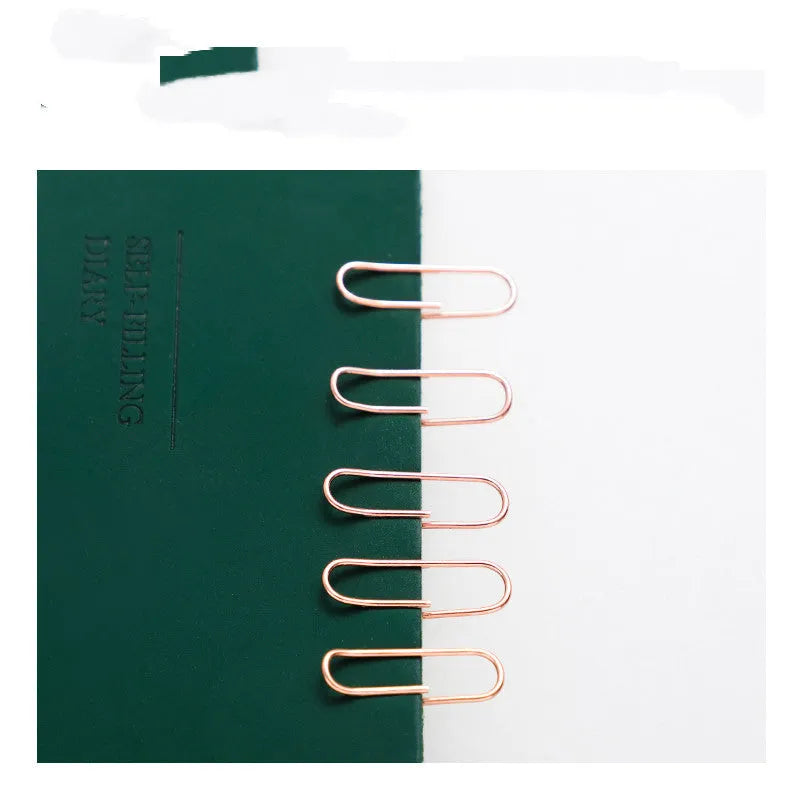Rose gold coloured heart-shaped metal paper clips, pack of 100 pieces.