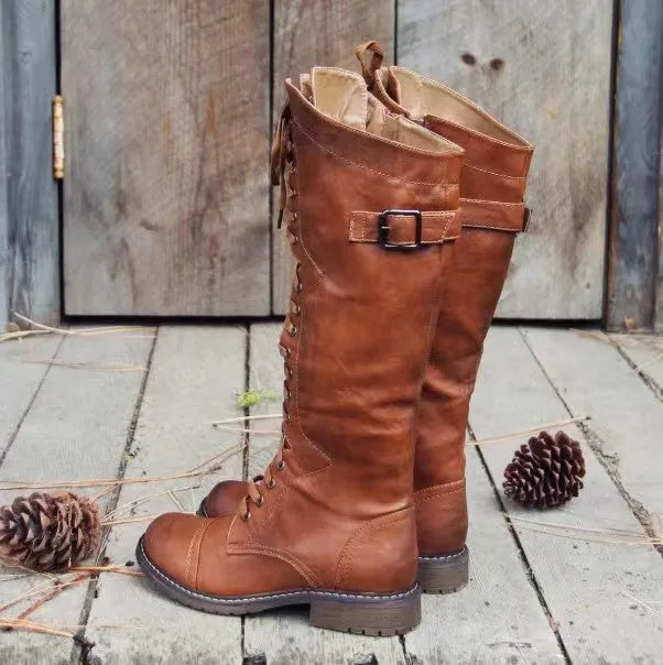 Black chunky heel high leg boots on a white background, showing round toe and stout low heel.
