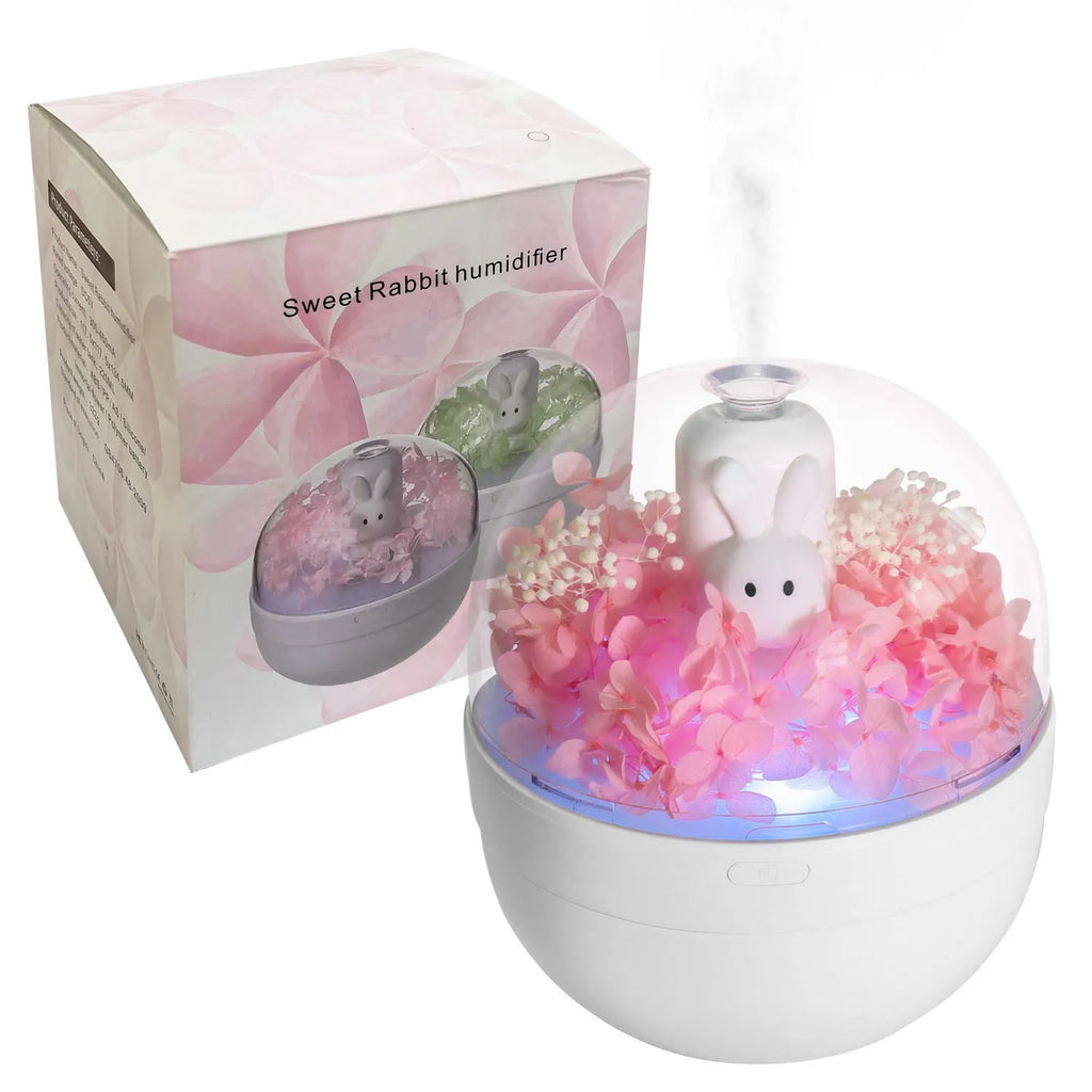 Pink ceramic rabbit vase with preserved flowers, functioning as an ultrasonic aromatherapy humidifier.