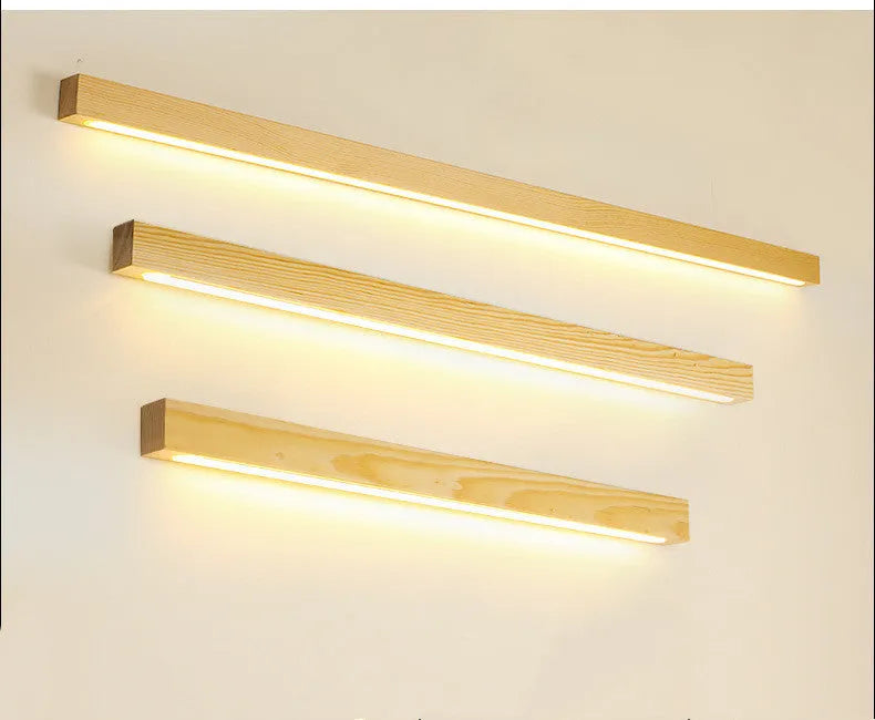 Walnut-coloured minimalist log strip wall lamp mounted on a wall.