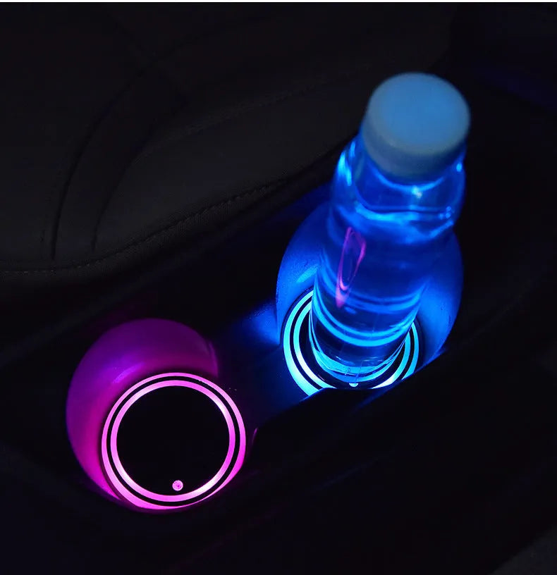 Colourful LED light-up coaster mat for car cup holder showing multiple light colours and USB cable.