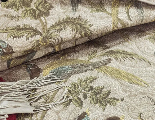 American-style floral quilted cotton bedspread in blue, shown draped on a double bed.