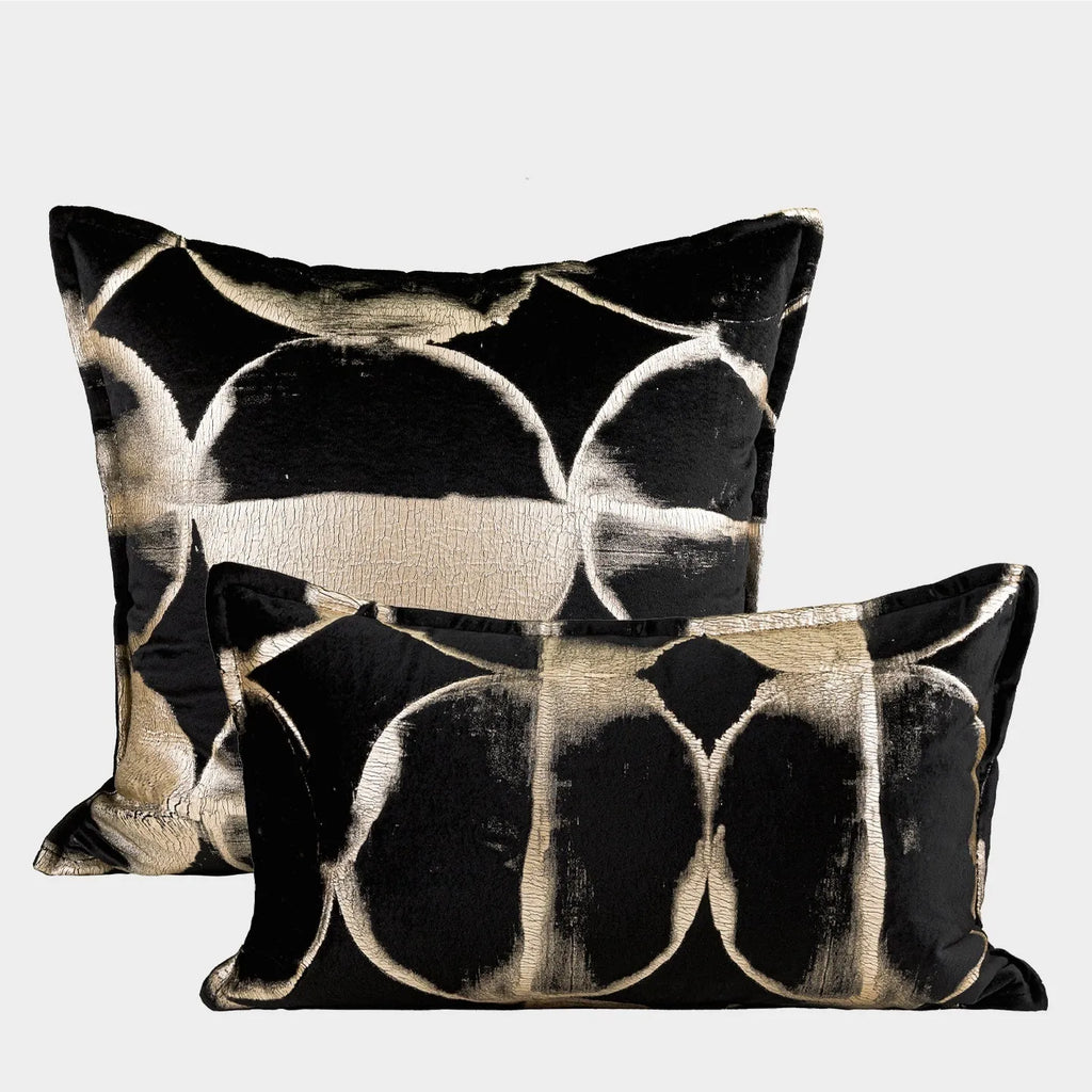 Black and gold abstract pattern flannel pillow cushion on a sofa, shown with removable cover.