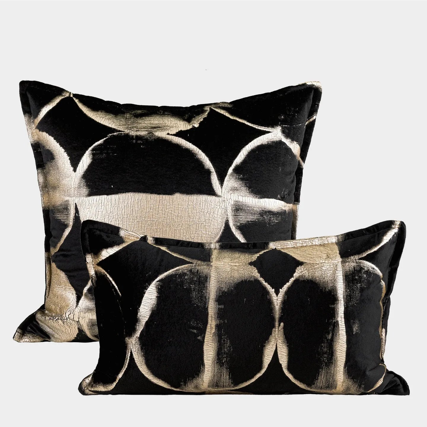 Black and gold abstract pattern flannel pillow cushion on a sofa, shown with removable cover.