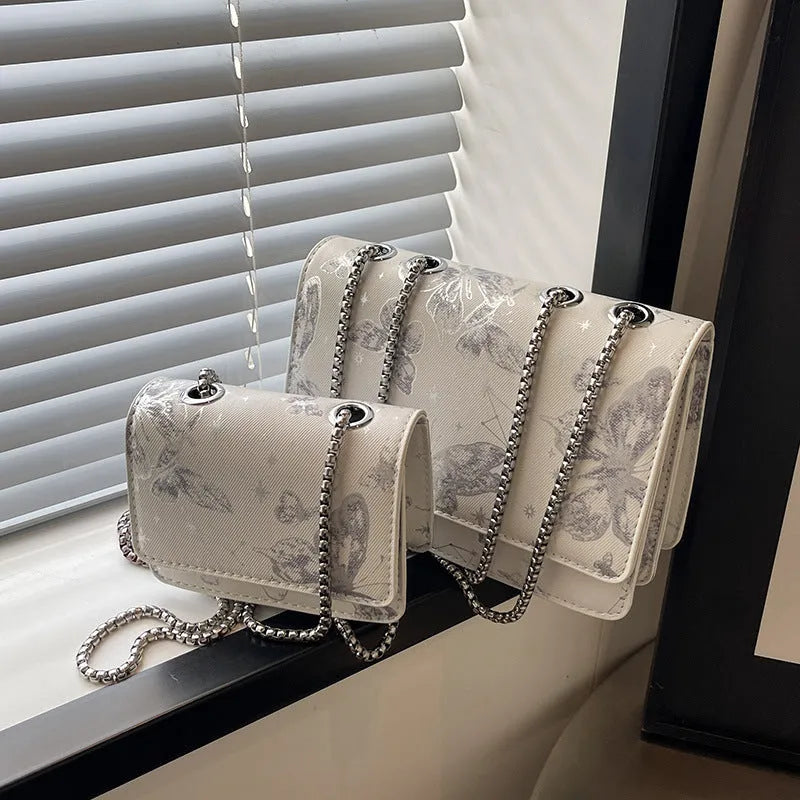 Corduroy chain crossbody bag for women in black, available in large and small sizes, with silver chain strap.