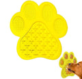Blue bone-shaped silicone dog licking mat with suction cups on a tiled shower wall.