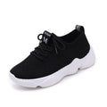 Women's white thick-soled sports shoes with flying woven upper and front strap.