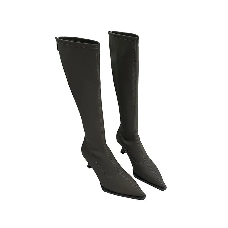 Women's black pointed toe stiletto boots with a back zipper, shown from the side.