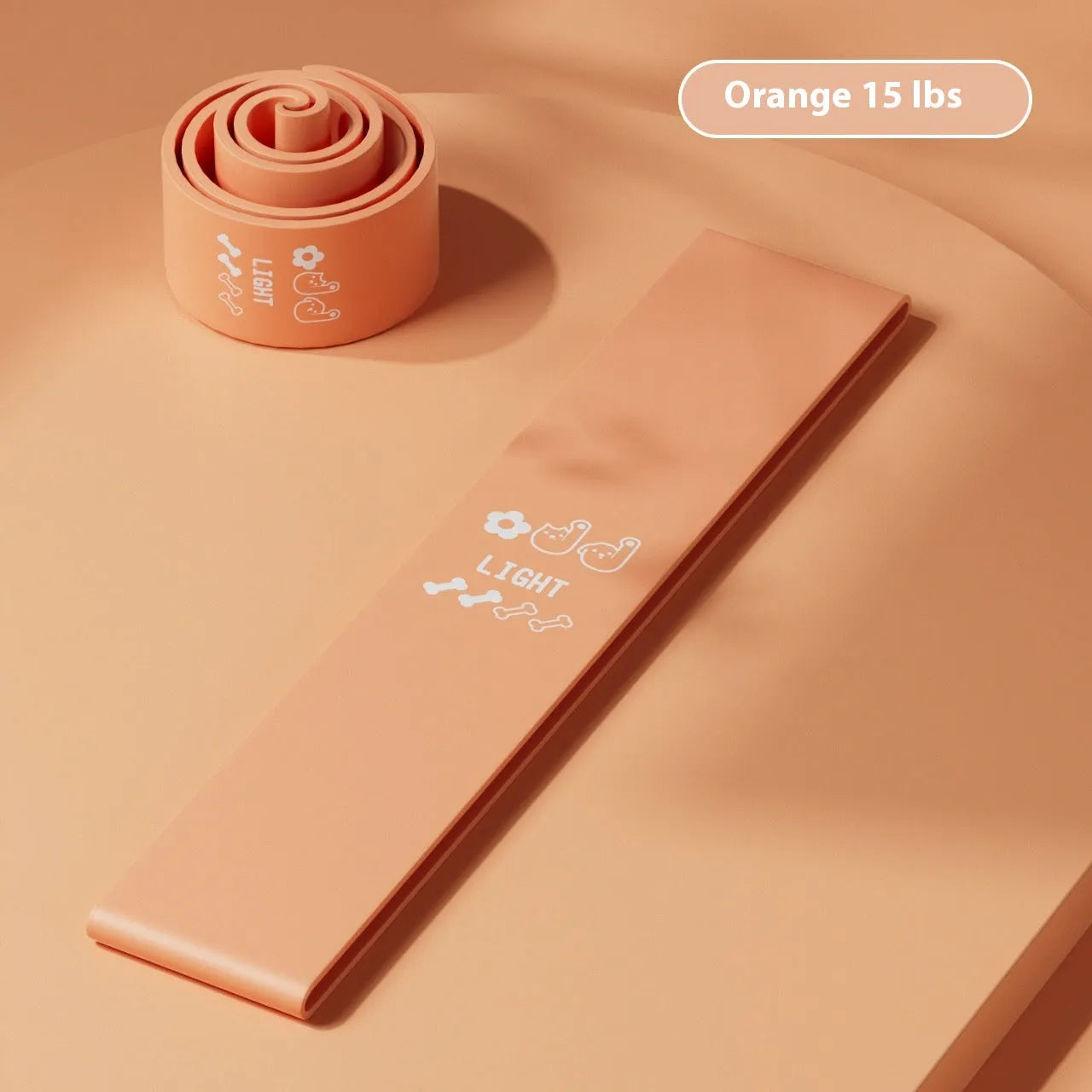 Plastic elastic resistance band in four colours: green, beige, orange, and pink representing different tension levels
