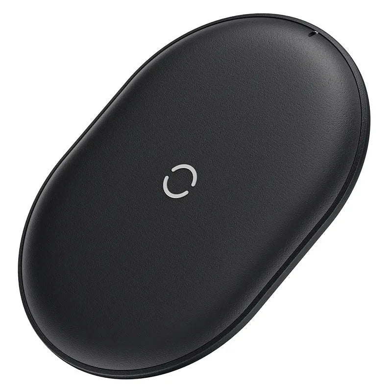 Baseus Rough 15W wireless charging pad in black on a table next to a mobile phone.