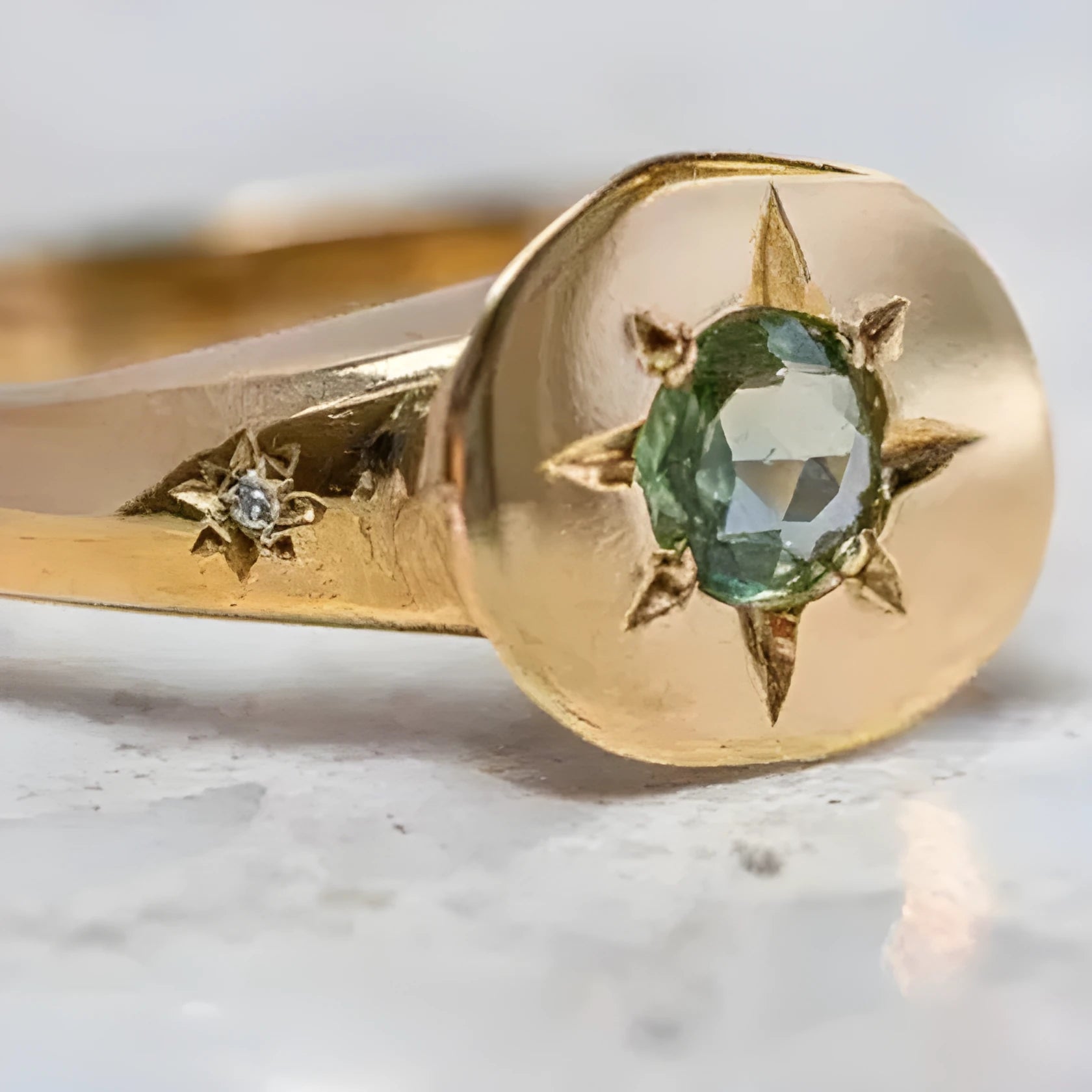 Gold colour adjustable ring with a star-shaped zircon stone set flush into an oval zinc alloy band.