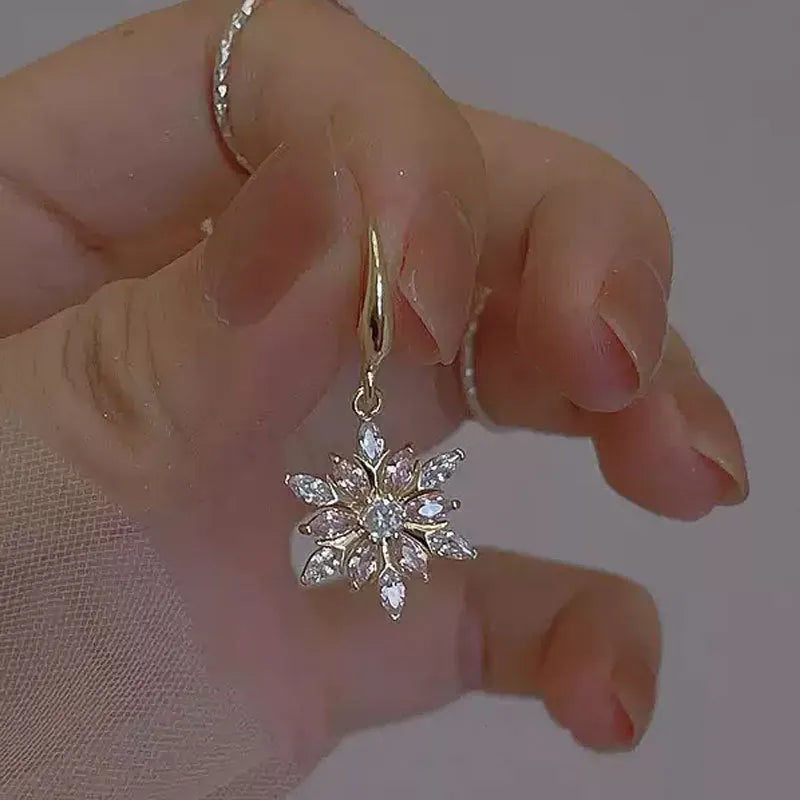 Gold alloy snowflake earrings with central zircon stone for women